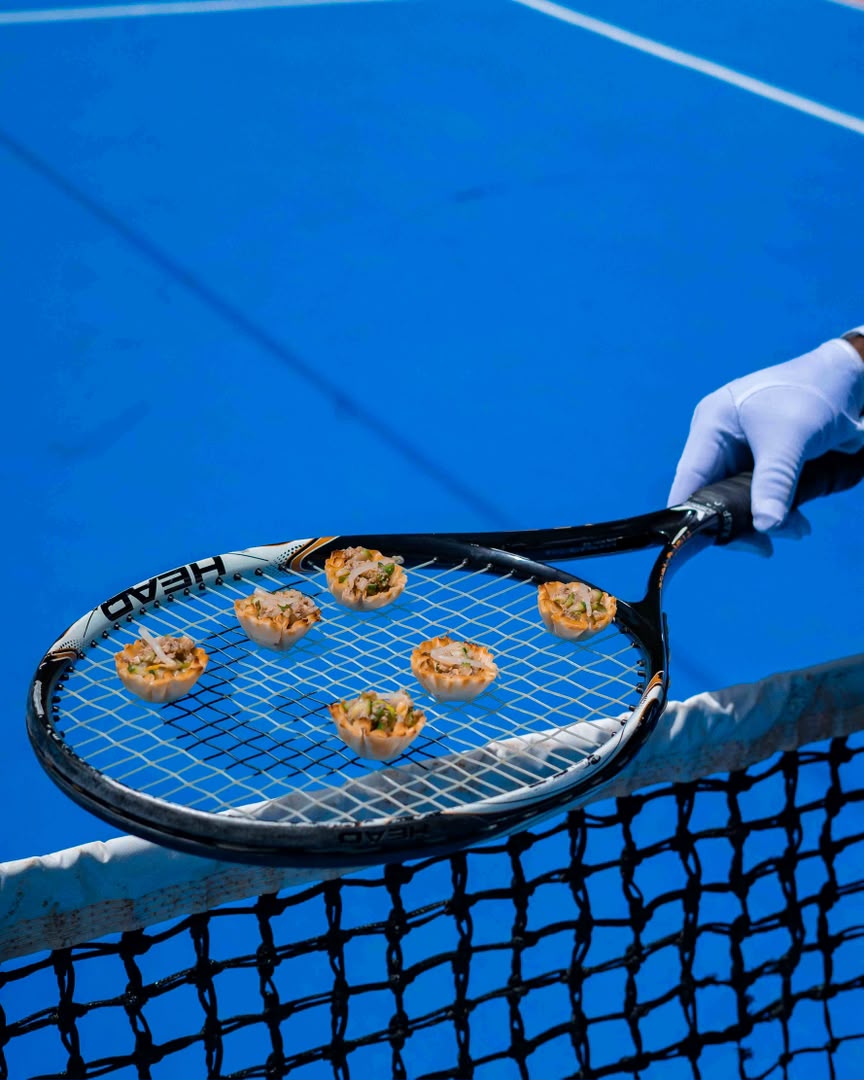 Bites served on a tennis racket above the net
